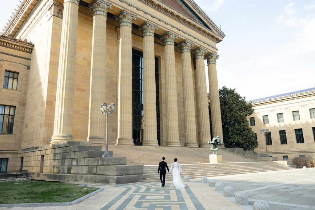 Bride-and-groom-sharing-a-quiet-moment-at-the-Philadelphia-Museum-of-Art-capturing-romantic-wedding-portraits-with-iconic-columns-and-soft-natural-light