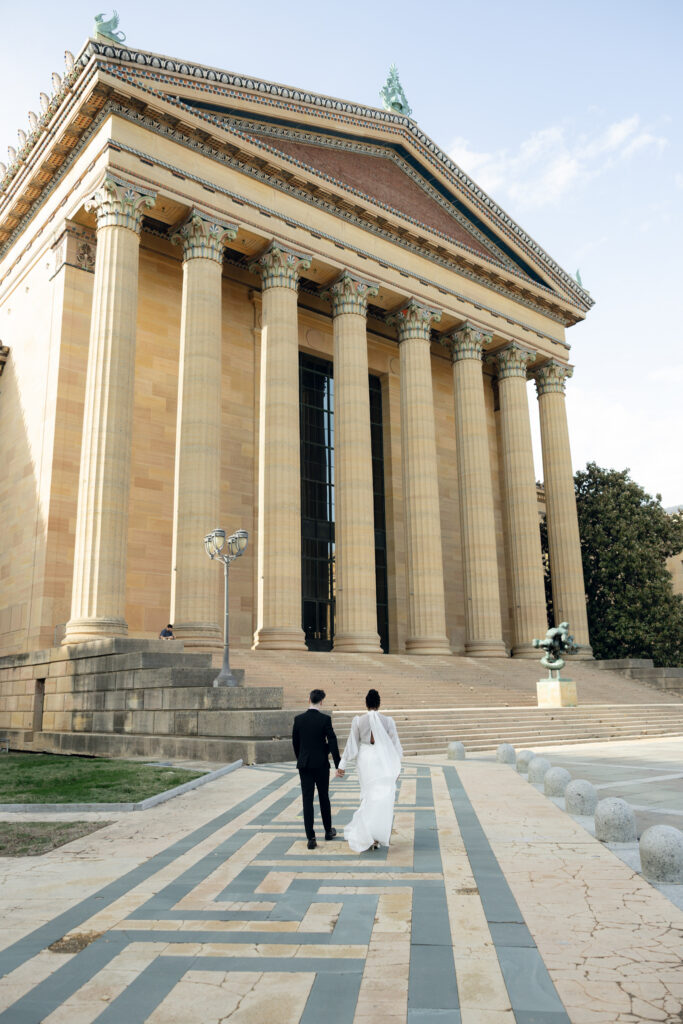 Bride-and-groom-sharing-a-quiet-moment-at-the-Philadelphia-Museum-of-Art-capturing-romantic-wedding-portraits-with-iconic-columns-and-soft-natural-light
