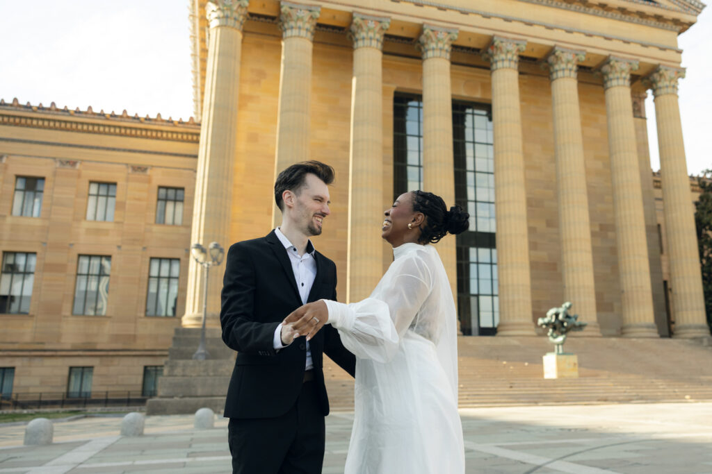 Bride-and-groom-sharing-a-quiet-moment-at-the-Philadelphia-Museum-of-Art-capturing-romantic-wedding-portraits-with-iconic-columns-and-soft-natural-light