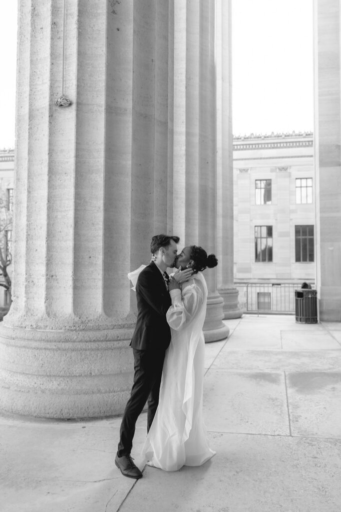 Bride-and-groom-sharing-a-quiet-moment-at-the-Philadelphia-Museum-of-Art-capturing-romantic-wedding-portraits-with-iconic-columns-and-soft-natural-light