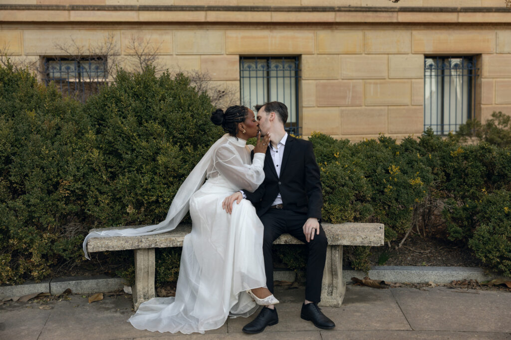 Bride-and-groom-sharing-a-quiet-moment-at-the-Philadelphia-Museum-of-Art-capturing-romantic-wedding-portraits-with-iconic-columns-and-soft-natural-light