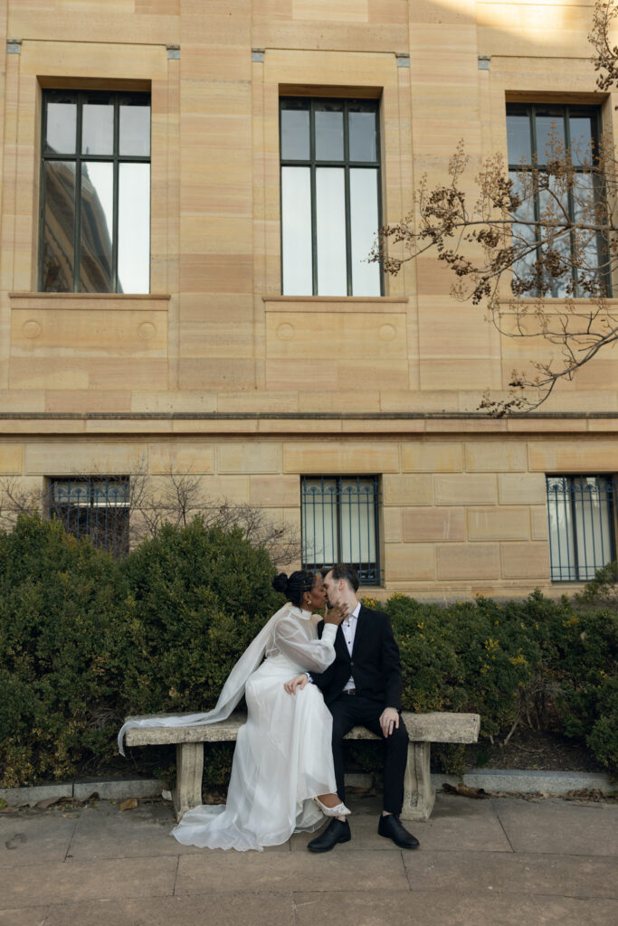 Bride-and-groom-sharing-a-quiet-moment-at-the-Philadelphia-Museum-of-Art-capturing-romantic-wedding-portraits-with-iconic-columns-and-soft-natural-light