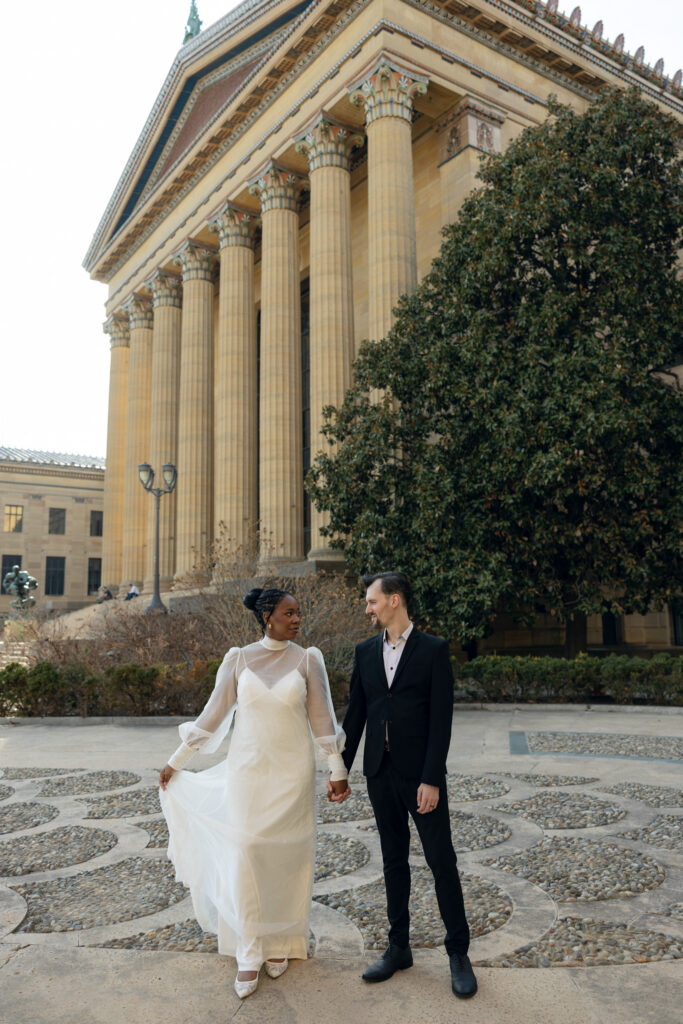 Bride-and-groom-sharing-a-quiet-moment-at-the-Philadelphia-Museum-of-Art-capturing-romantic-wedding-portraits-with-iconic-columns-and-soft-natural-light