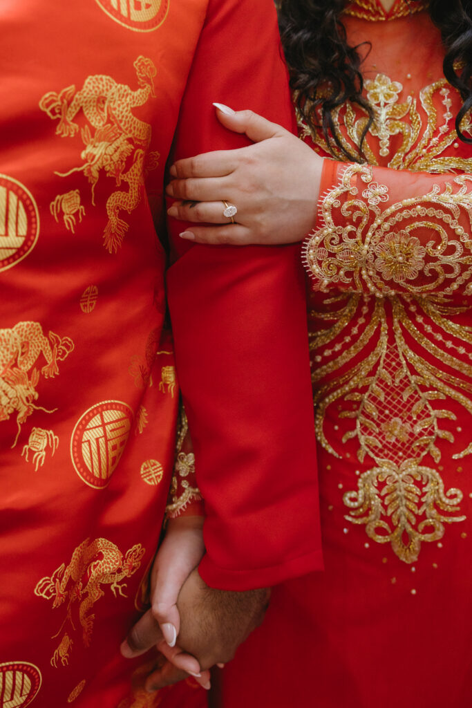 Couple-laughing-together-during-an-engagement-session-in-Philadelphia-Chinatown-with-city-lights-and-historic-architecture