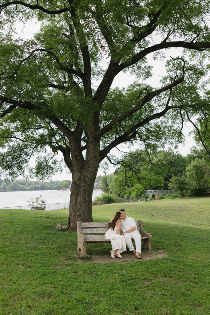 Elegant-couple-embracing-during-their-engagement-session-at-Fairmount-Water-Works-in-Philadelphia-with-the-Schuylkill-River-and-historic-architecture-in-the-background