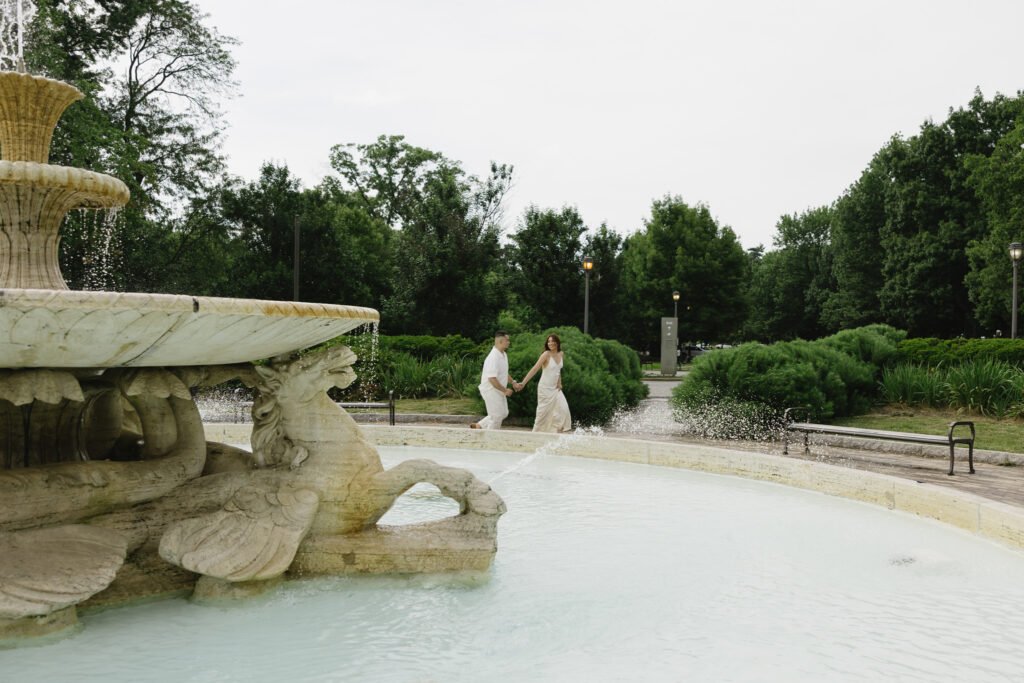 Elegant-couple-embracing-during-their-engagement-session-at-Fairmount-Water-Works-in-Philadelphia-with-the-Schuylkill-River-and-historic-architecture-in-the-background