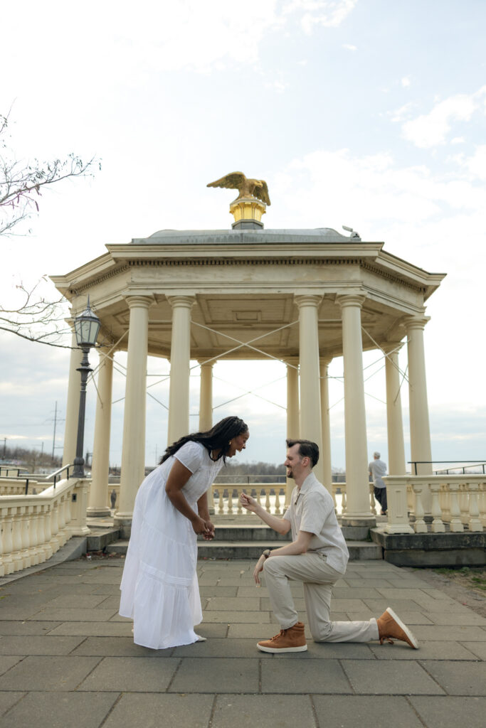 fairmount waterworks couple proposing in front of beautiful architecture backdrop in philadelphia