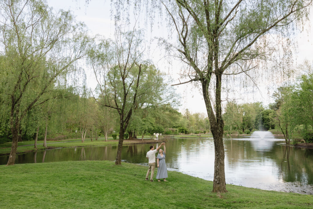 Romantic-engagement-photos-of-a-couple-walking-hand-in-hand-through-The-Willows-Park-in-Villanova-Pennsylvania